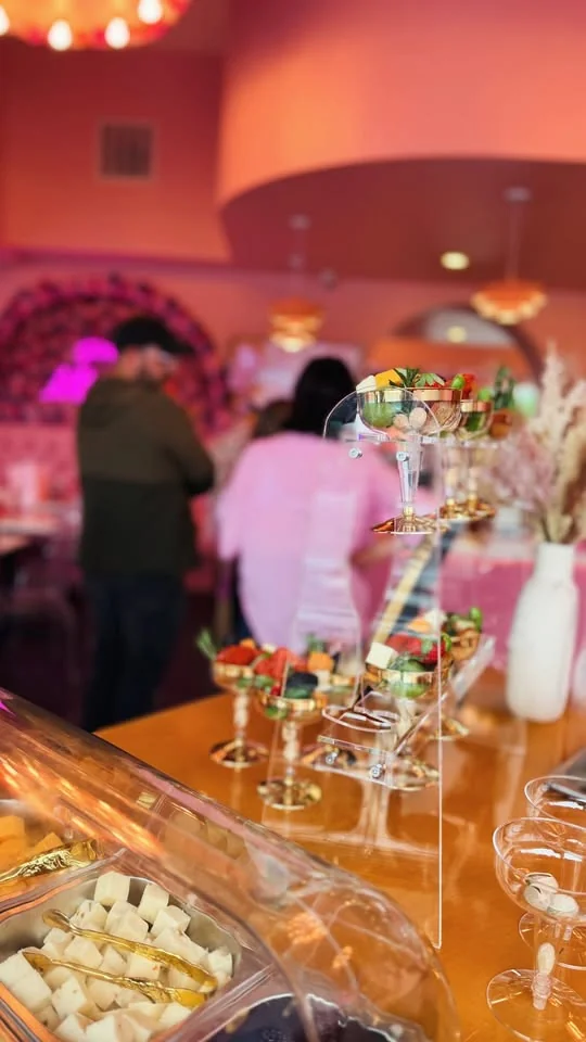 Rows of individual charcuterie cups arranged on an event bar