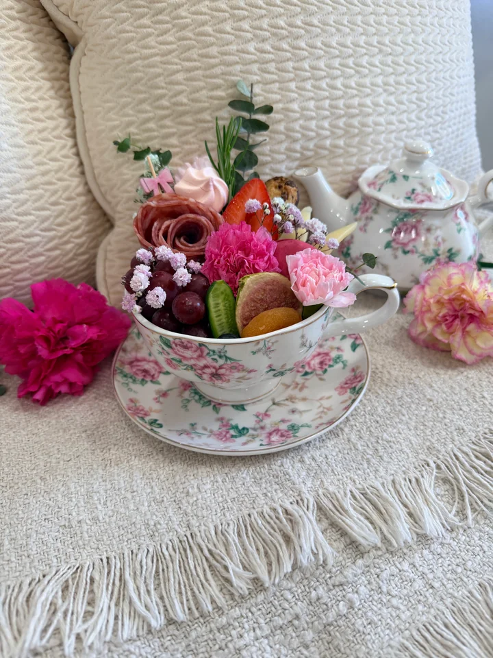 Floral keepsake tin filled with charcuterie and flowers