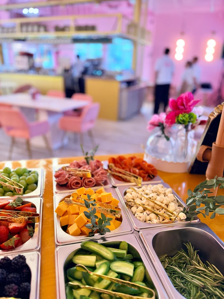Colorful charcuterie buffet with vegetables, meats, cheese, and crackers