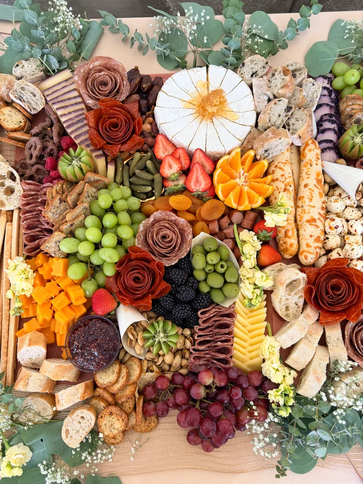 Large colorful charcuterie spread arranged for a celebration