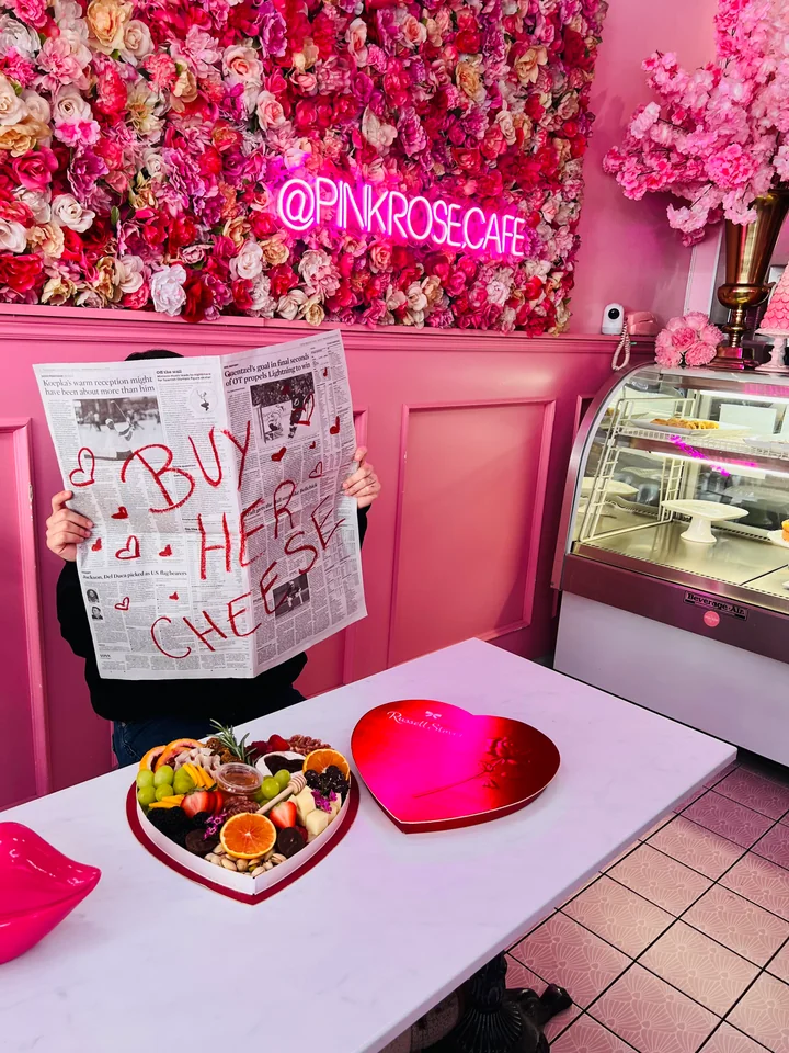 Bright pink venue with flower wall and intimate event table