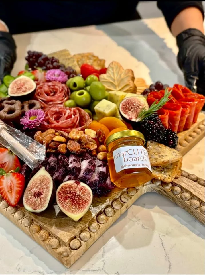 Signature charcuterie board with berries, figs, cheese, and cured meats