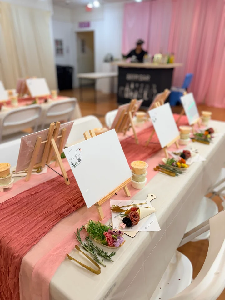 Long event table arranged with florals and individual workshop place settings